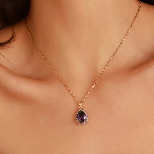 Minimalist gold water drop pendant necklace with a sculptural teardrop shape on a fine cable chain